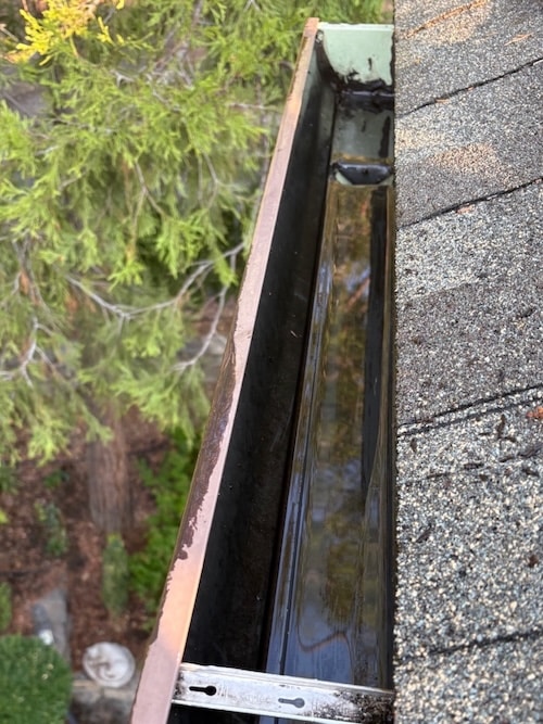 Clean gutters after removal of leaves and debris in Ashland OR